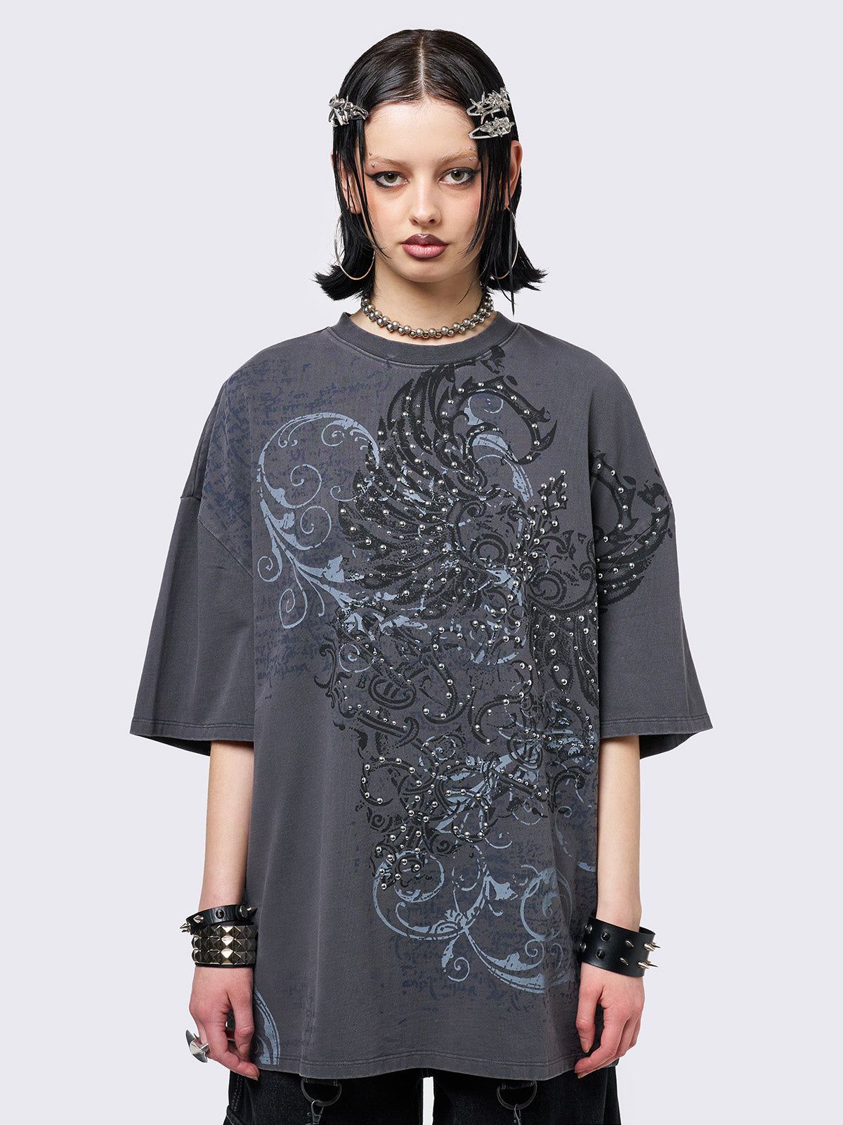 Grey washed t-shirt with grunge wings graphic front print featuring studded details.