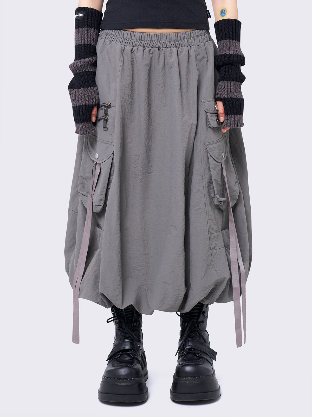 Grey bubble midi skirt featuring balloon style and utility cargo pockets with straps.
Elasticated waist