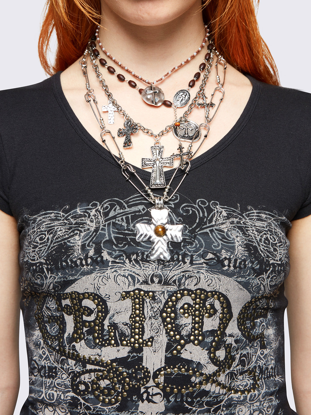 Set of 4 layered necklaces featuring multiple cross pendants:
Rosary beads, beaded chain, and safety pin chain.