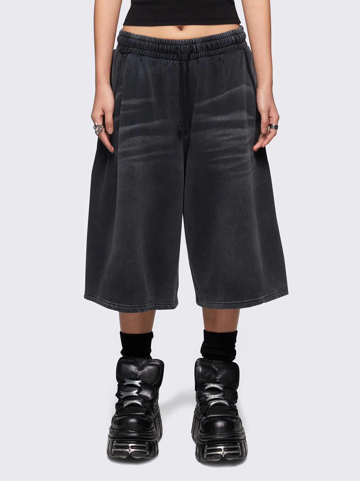 Black washed longline sweat shorts with signature embroidered back pocket detail, elasticated drawstring waist and oversized fit.