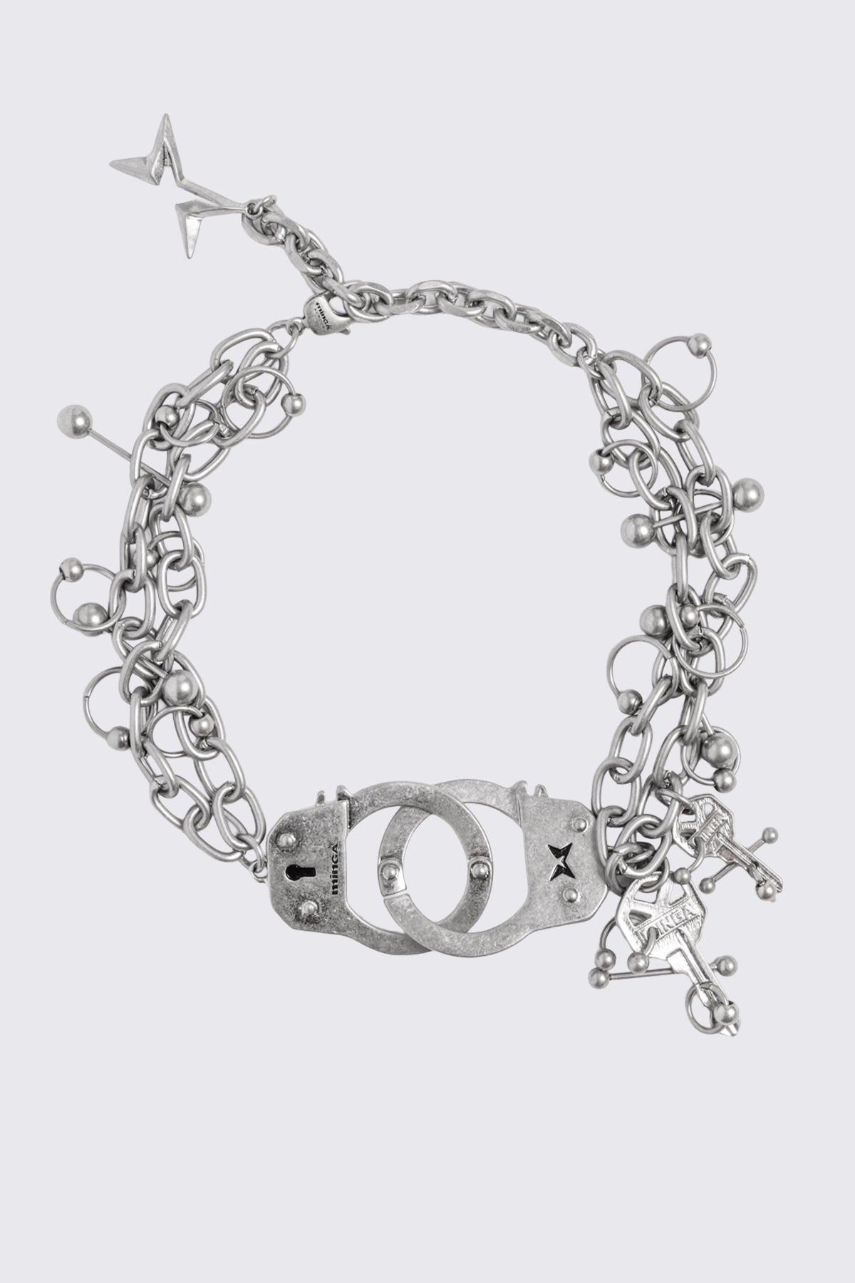 Chunky necklace in antique silver with handcuff, key and piercing charms in a grunge goth style.