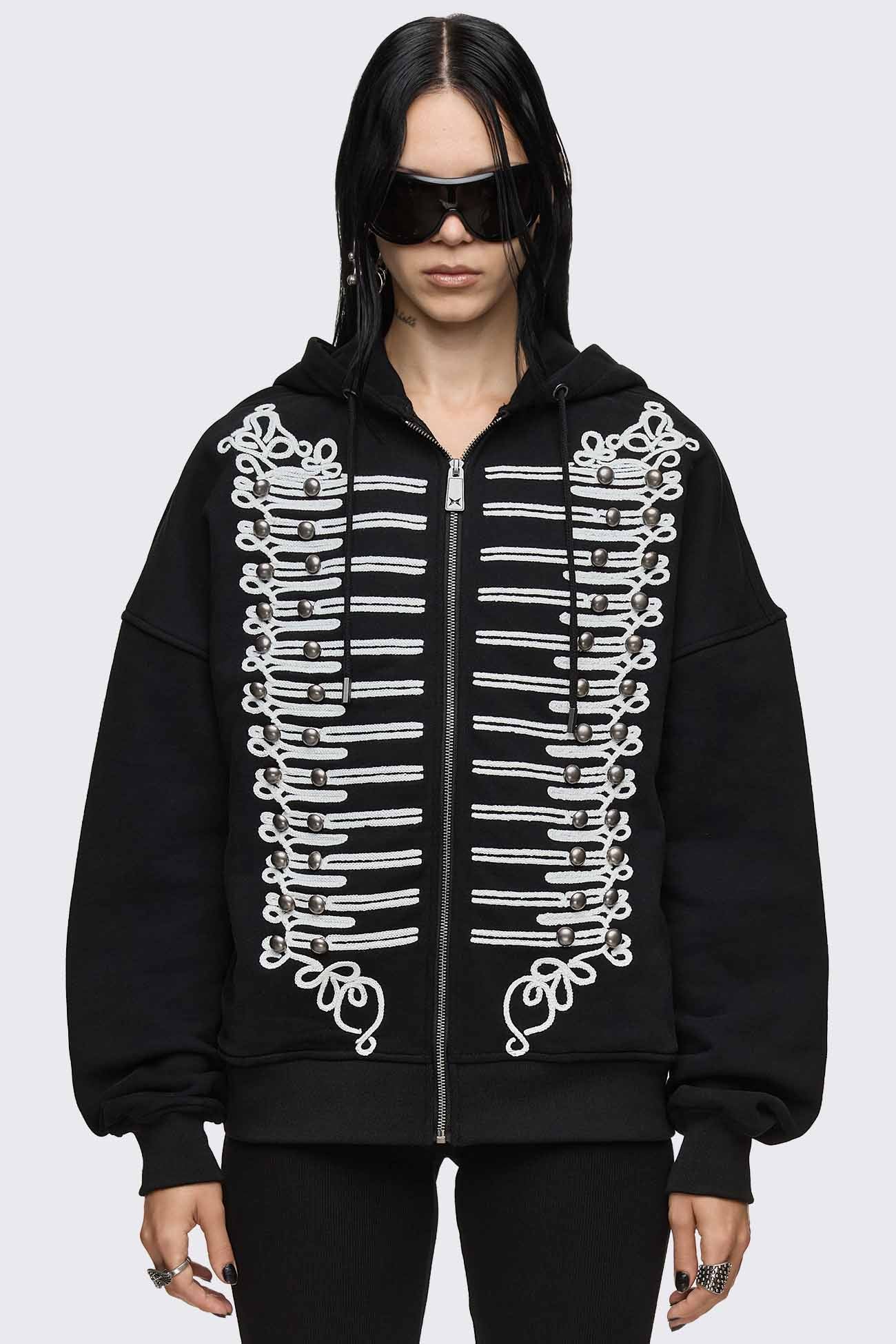 Black zip up hoodie with white braided embroidery, silver button details and oversized fit.