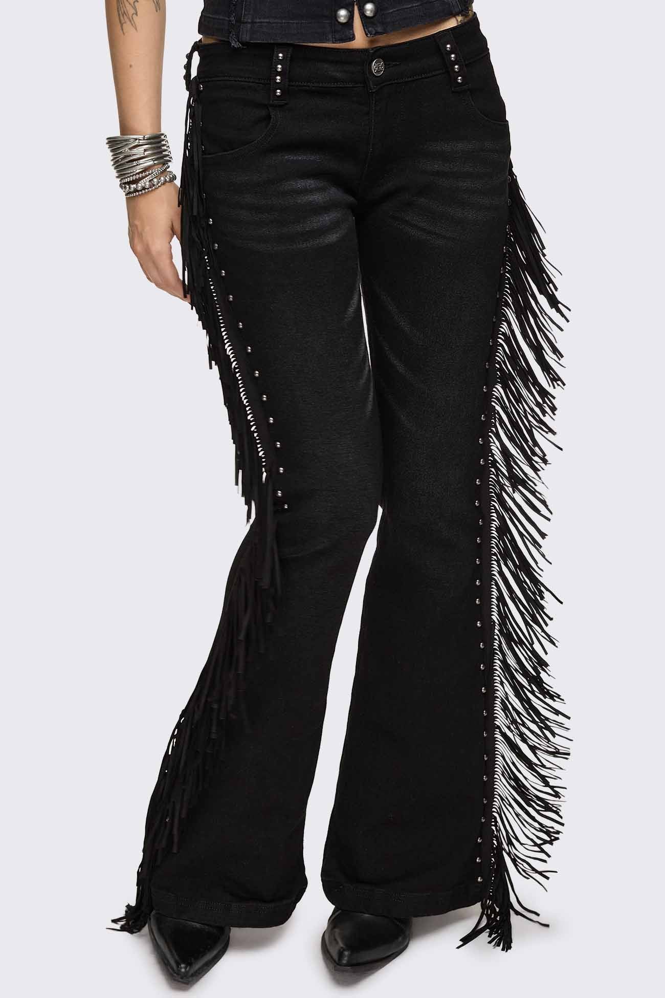 Black flared jeans with long fringe trim, silver stud details and a low-rise waist.