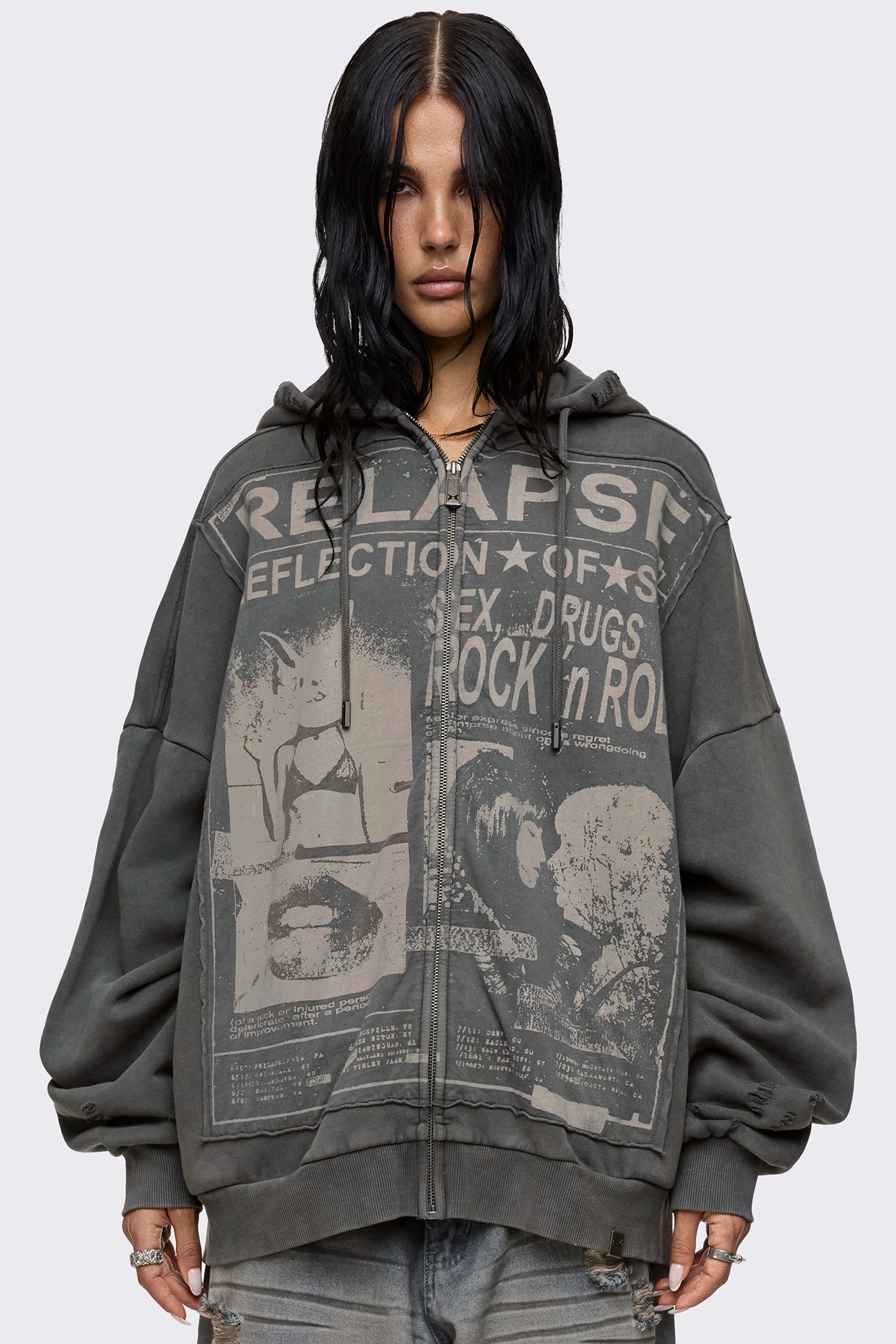 Grey washed zip up hoodie with Relapse graphic print, distressed details and oversized fit on model.