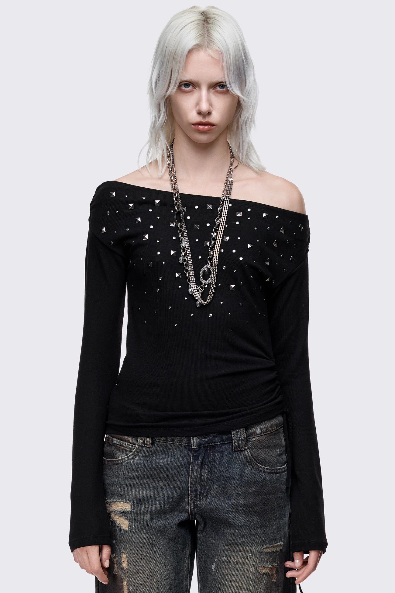 Black long sleeve top with stud details and off-shoulder style.