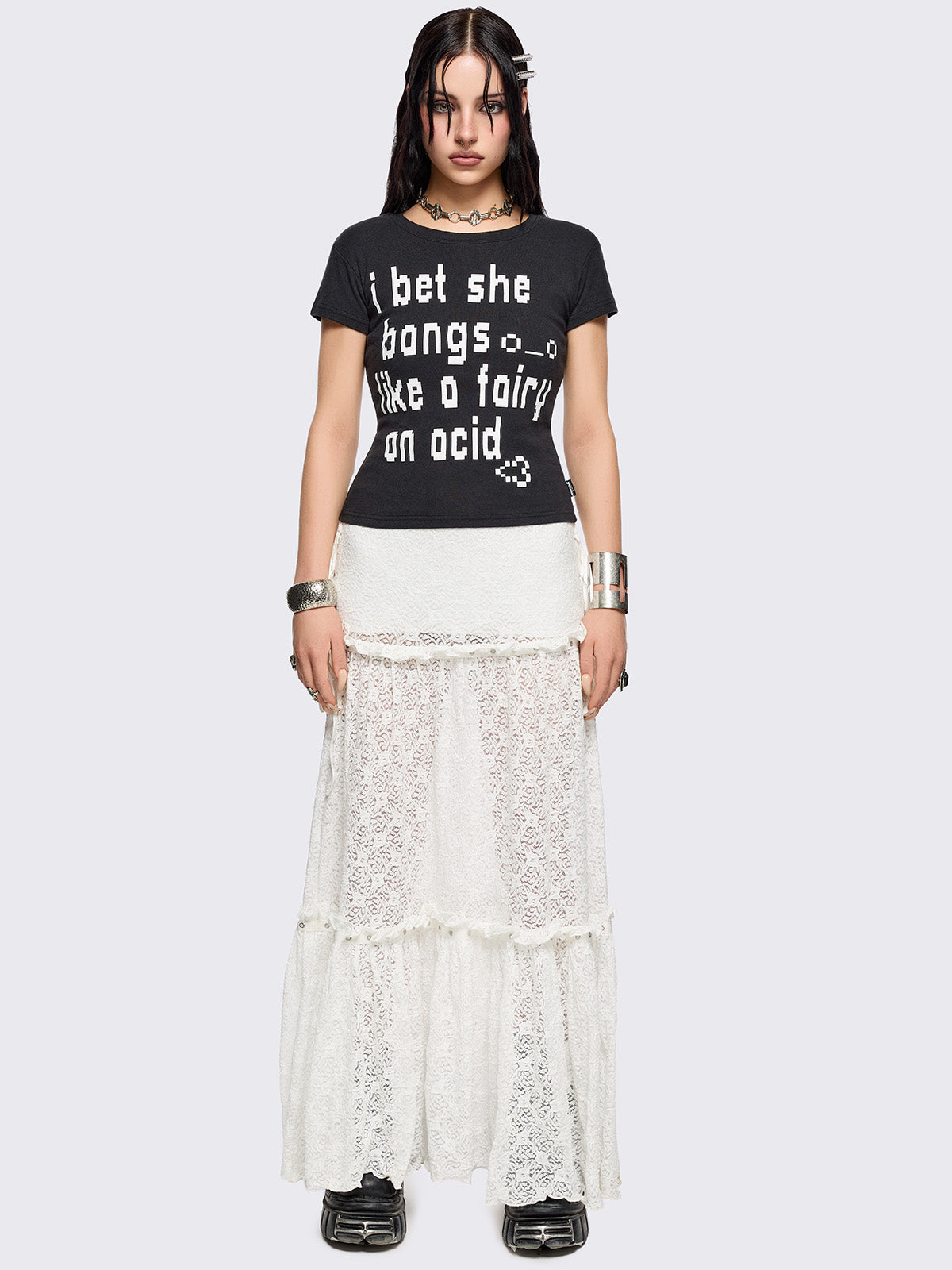 White floral lace maxi skirt with tiered lace layers with ruffles, lace-up sides with bow ties and eyelet trim details.