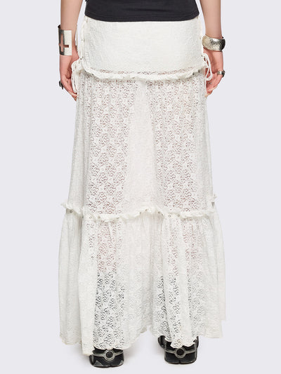 White floral lace maxi skirt with tiered lace layers with ruffles, lace-up sides with bow ties and eyelet trim details.