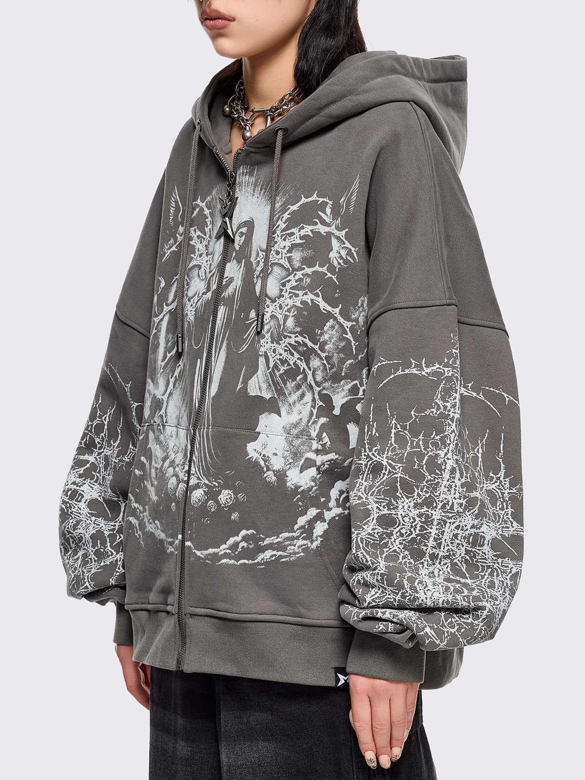 Grey zip up hoodie jacket featuring a sacred figure graphic on front and thorn sleeve prints.