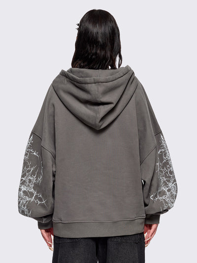 Grey zip up hoodie jacket featuring a sacred figure graphic on front and thorn sleeve prints.