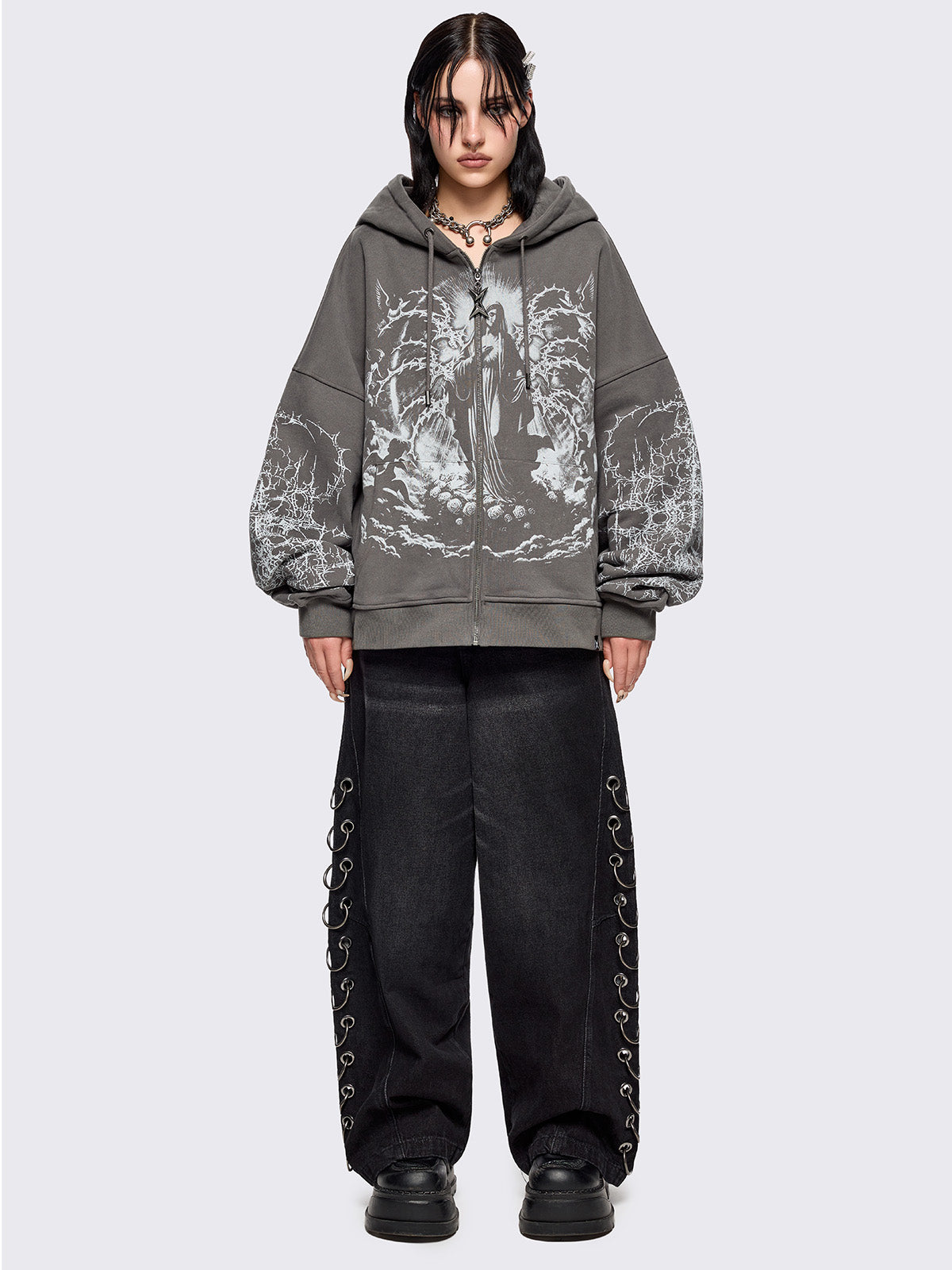 Grey zip up hoodie jacket featuring a sacred figure graphic on front and thorn sleeve prints.