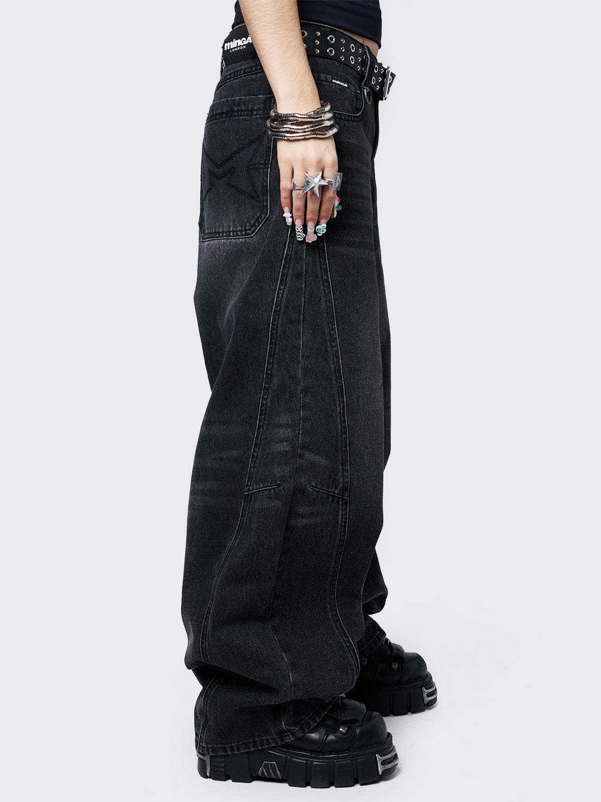 Black washed super baggy jeans with a relaxed fit, regular waist, zip fly, button fastening, and belt loops. Trendy streetwear style.