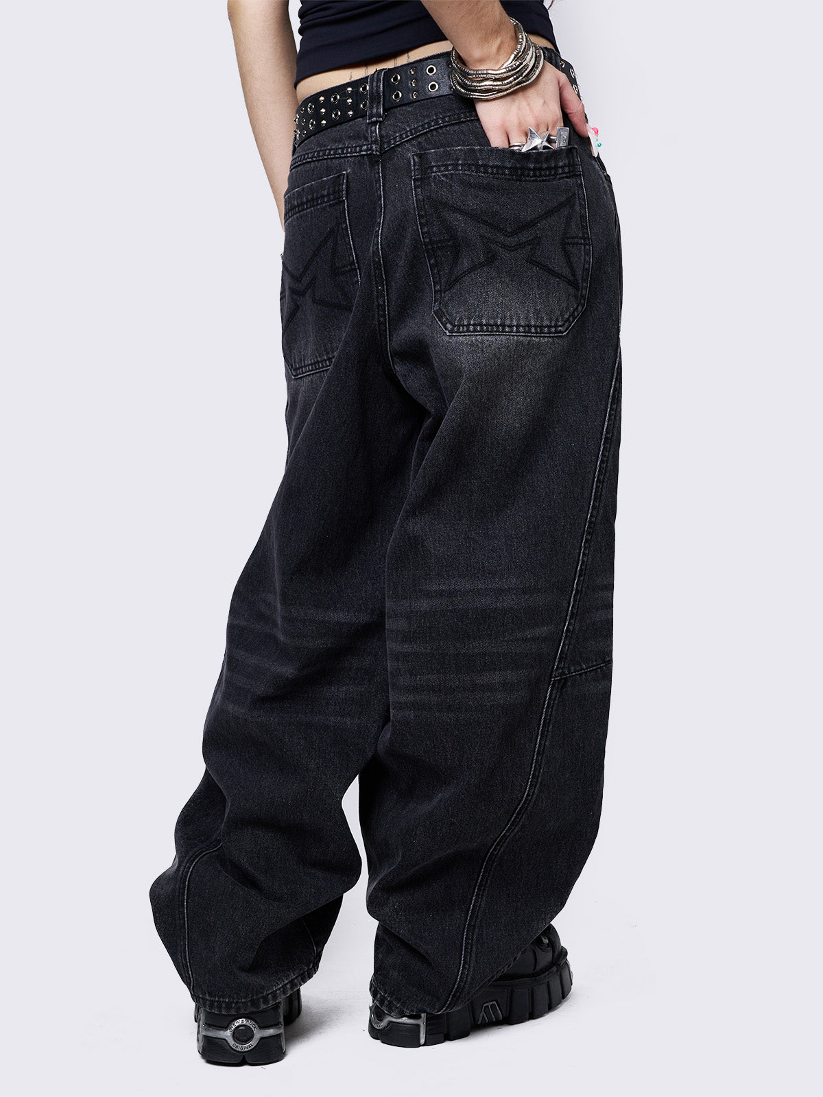 Black washed super baggy jeans with a relaxed fit, regular waist, zip fly, button fastening, and belt loops. Trendy streetwear style.