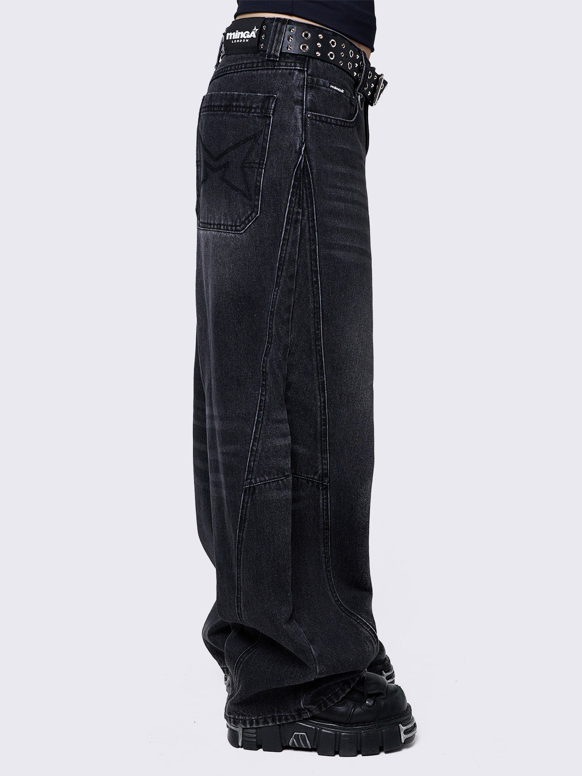 Black washed super baggy jeans with a relaxed fit, regular waist, zip fly, button fastening, and belt loops. Trendy streetwear style.