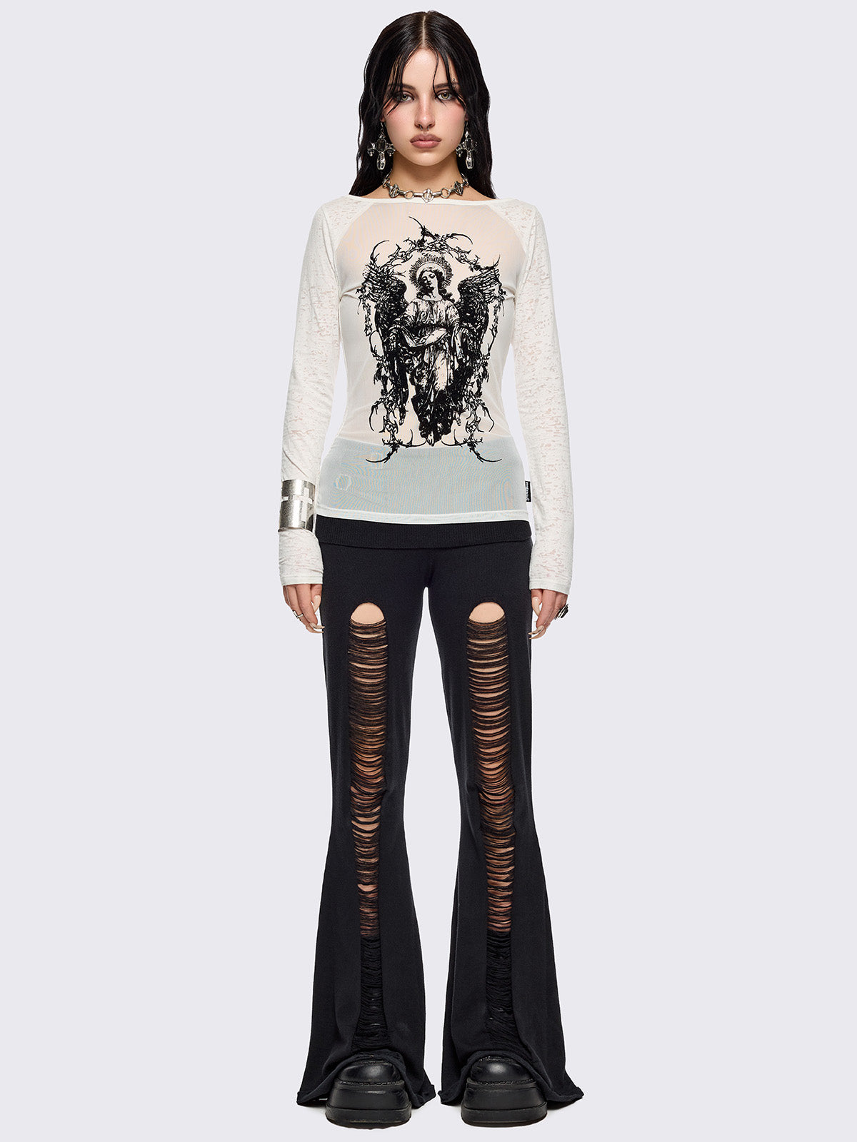 White semi-sheer long sleeve top with a sacred figure graphic front print and mesh contrast.