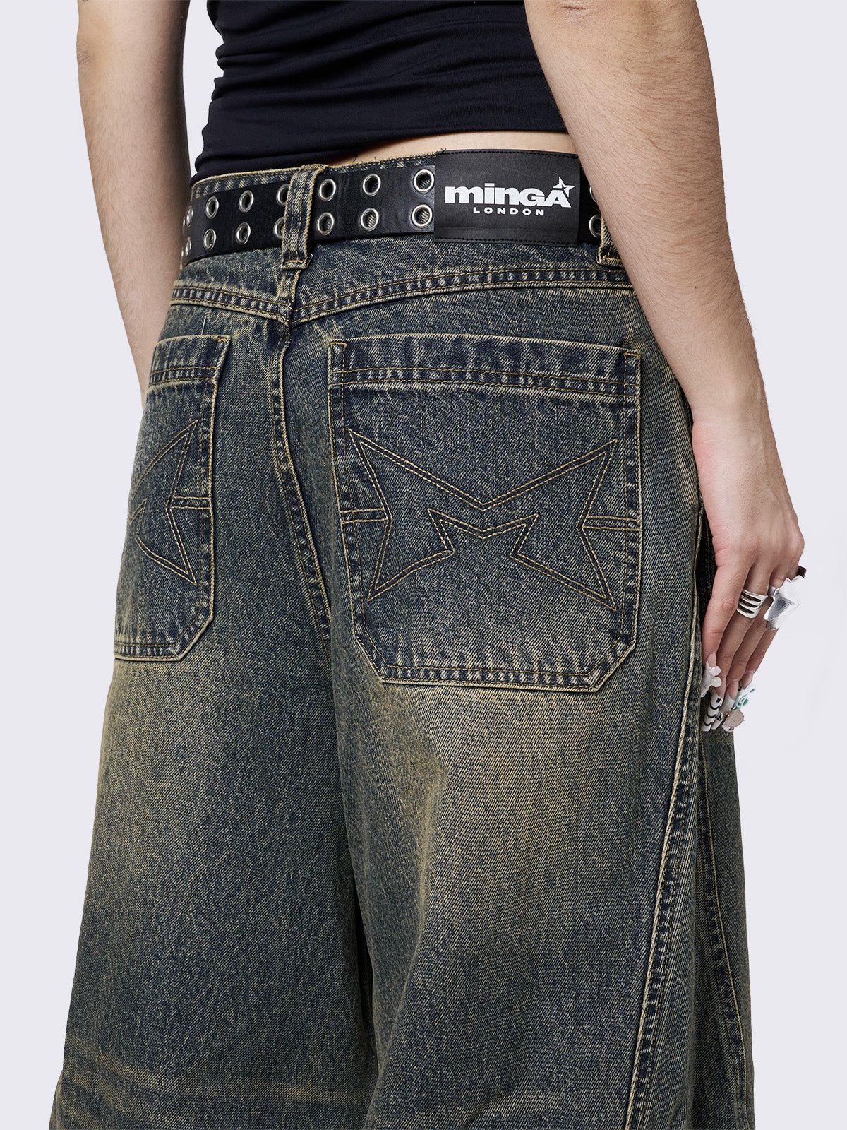 Blue washed super baggy jeans with green overdye, a relaxed fit, regular waist, zip fly, button fastening, and belt loops. Trendy streetwear style.