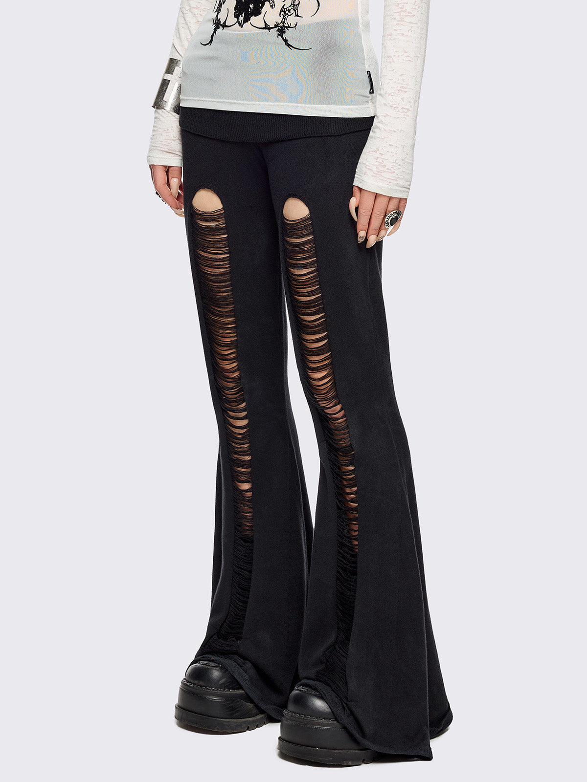Black distressed flare pants with ribbed waistband. 