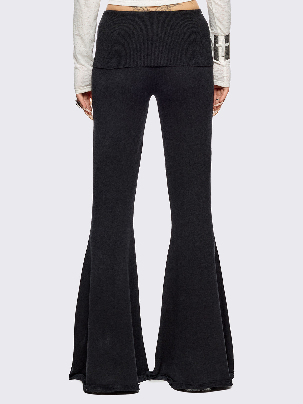 Black distressed flare pants with ribbed waistband. 