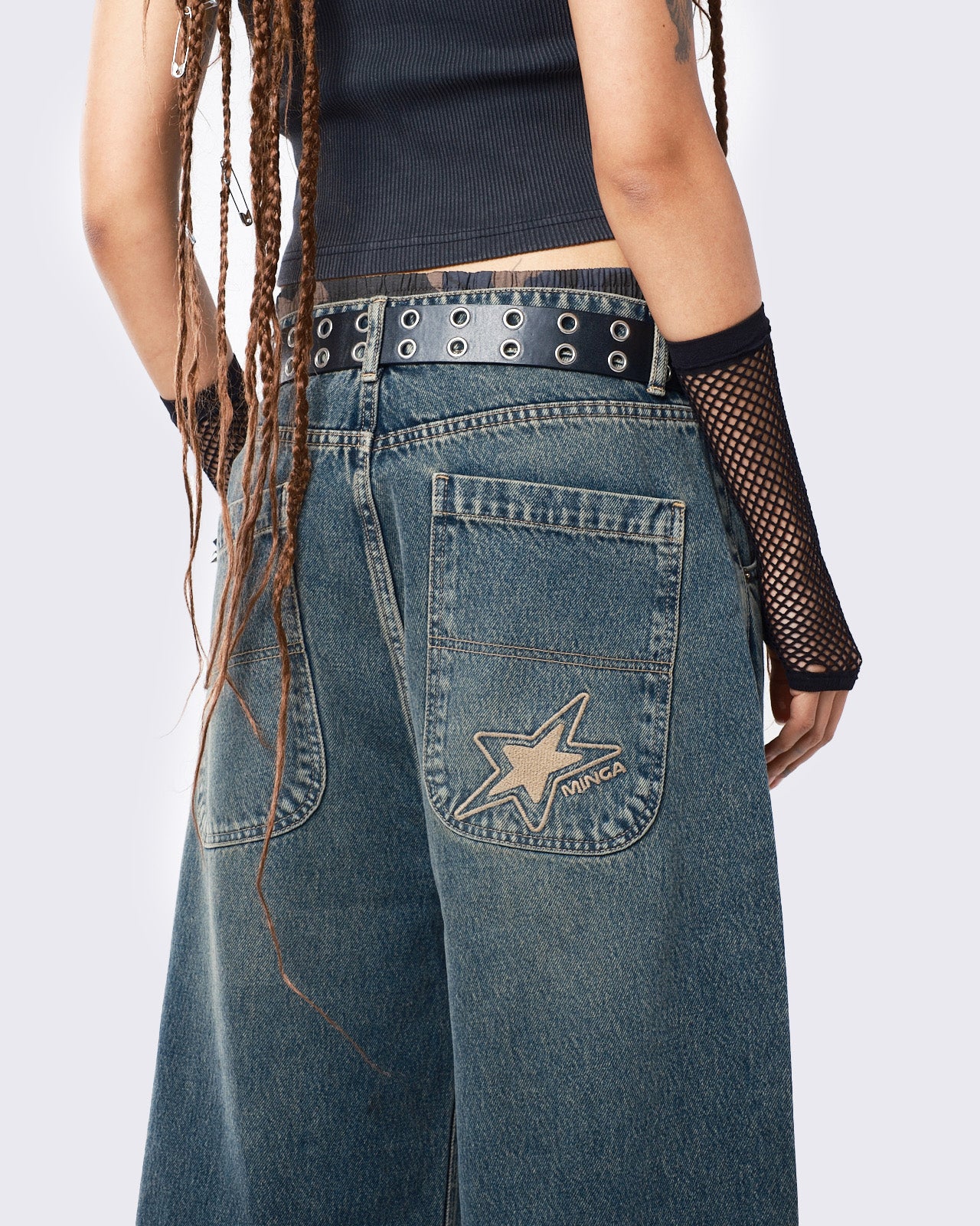 Baggy jeans in washed light blue with green overdye, Minga Star back embroidery, wide leg, regular waist, and relaxed fit. Y2K-inspired and grunge aesthetic.
