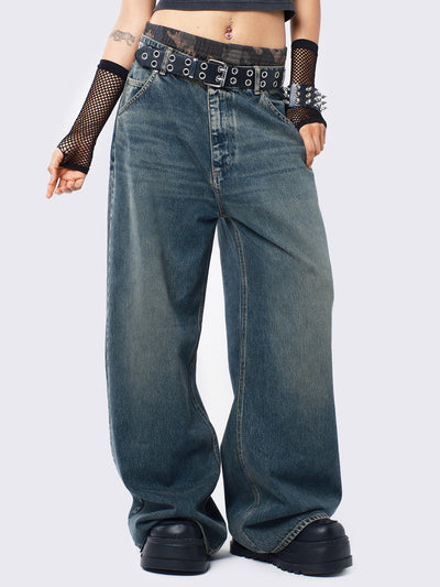 Baggy jeans in washed light blue with green overdye, Minga Star back embroidery, wide leg, regular waist, and relaxed fit. Y2K-inspired and grunge aesthetic.
