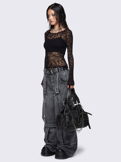 Black faux leather shoulder bag with silver chains, spike charms, side pockets, and embroidered cross detail on the front.