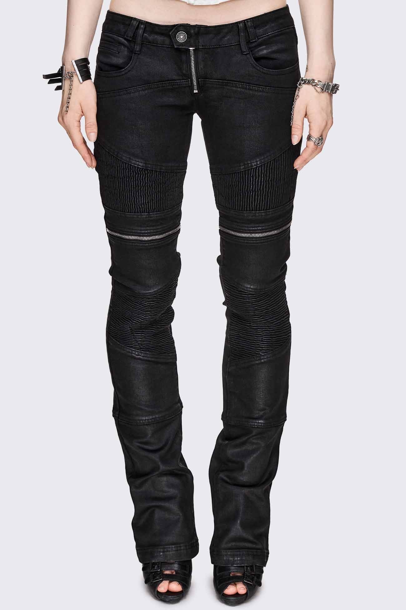 Bootcut jeans in black coated denim with ribbed paneling and zipper details, low-rise grunge aesthetic.