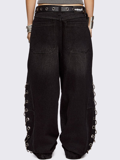 Black washed super baggy jeans with silver chunky eyelets along sides with O-rings. Oversized fit.