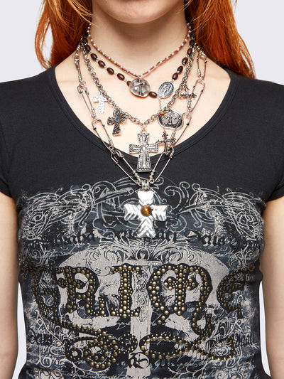 Set of 4 layered necklaces featuring multiple cross pendants: 
Rosary beads, beaded chain, and safety pin chain.