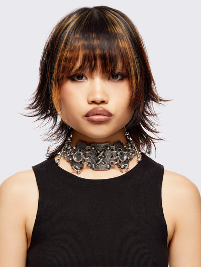 Chunky choker necklace featuring multi-layer chain design with oversized rings, metal hardware and piercing details.
