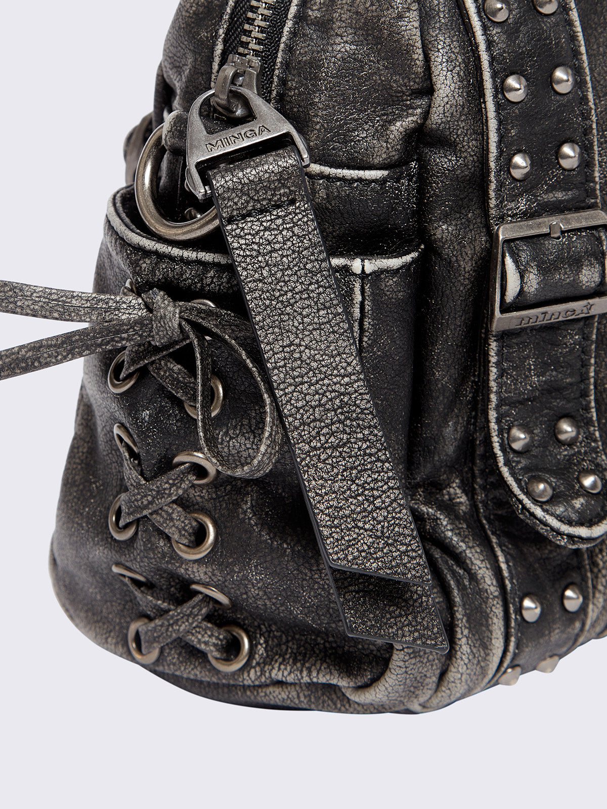 Black washed faux leather shoulder bag with multiple D-rings, buckles and hardware details, worn on shoulder with lace-up strap design.