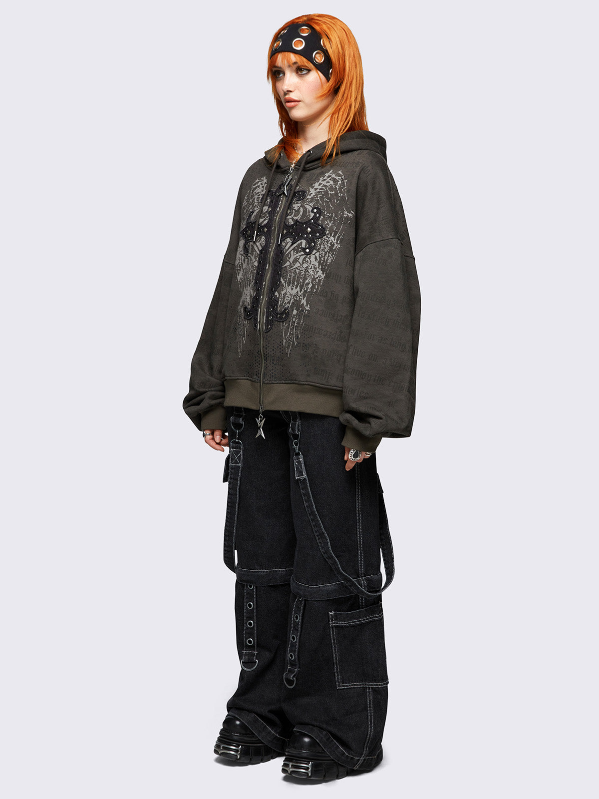 Khaki zip up hoodie jacket featuring a letterings and wings graphic print and cross patch with studded details.