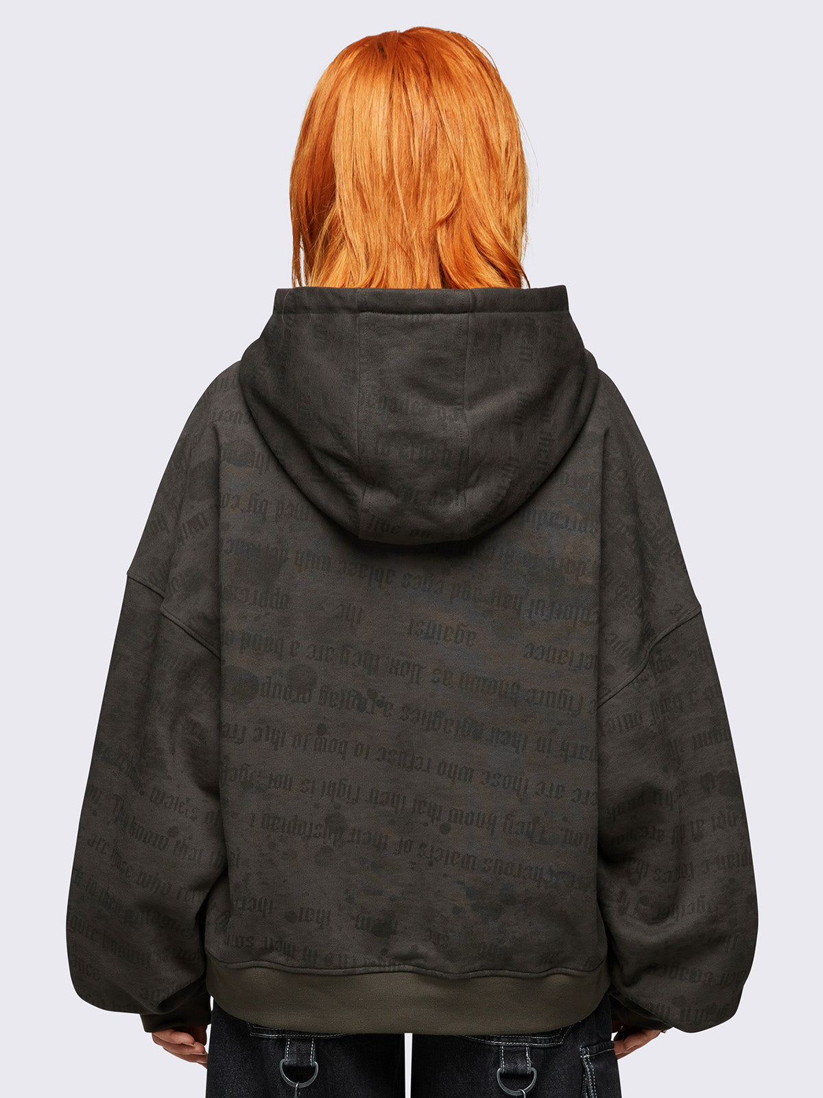 Khaki zip up hoodie jacket featuring a letterings and wings graphic print and cross patch with studded details.