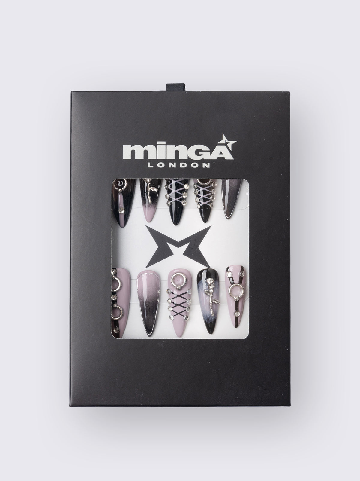 Set of stiletto press-on nails features a bold black and dusty pink ombré base, detailed with metallic piercing accents, faux corset lacing, and 3D charm embellishments. Perfect for adding edge to your outfit without a trip to the salon.