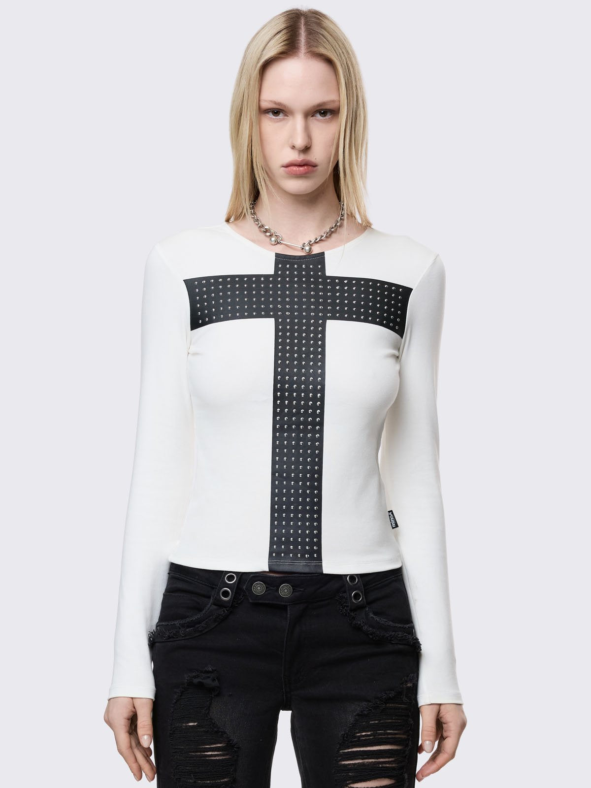 White long sleeve top with black chunky cross with silver studs