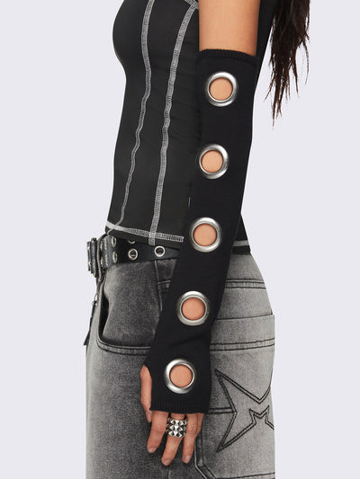 Black arm warmers with metallic hole details and thumbhole cuffs.