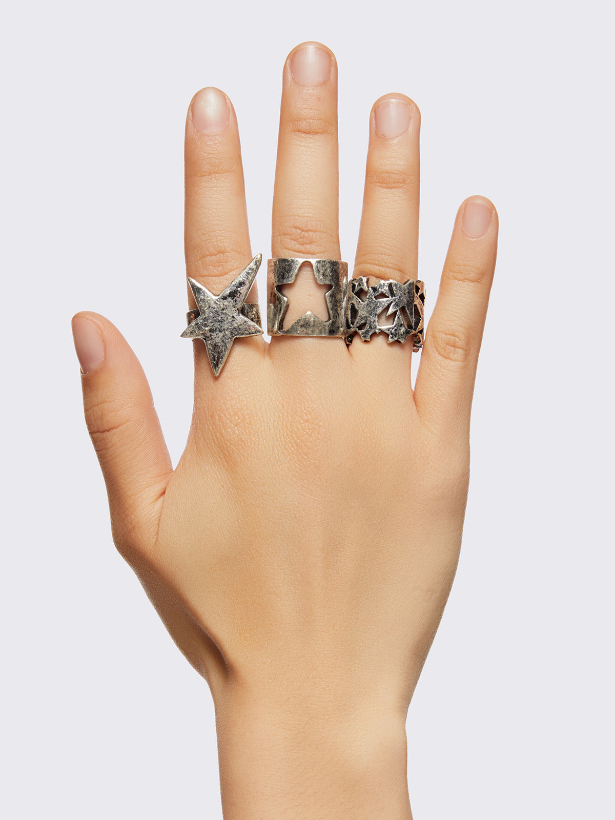 Set of 6 silver chunky rings with multiple star designs.