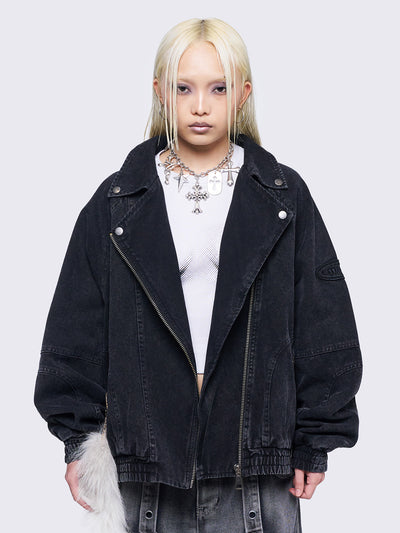 Black washed twill bomber jacket with wide lapel collar, asymmetric zip closure, oversized fit, and seam details. Features an elasticated hem, cuffs, side pockets, and an embroidered sleeve patch.