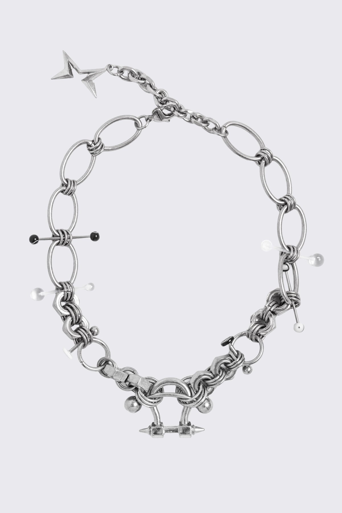 Chunky silver necklace with piercing and industrial details. 