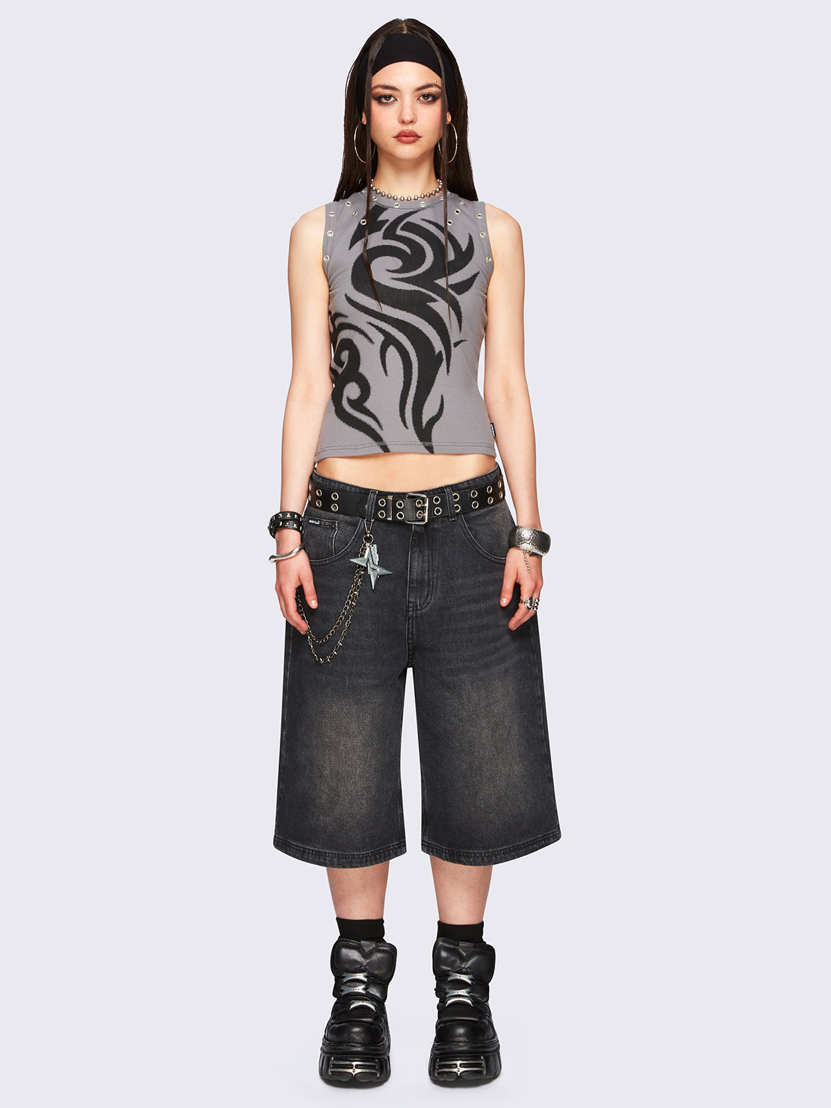 Black washed longline denim jorts with removable chain and wide-leg fit and knee-length cut.