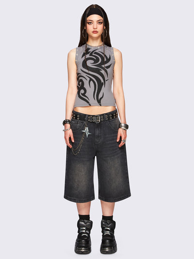 Black washed longline denim jorts with removable chain and wide-leg fit and knee-length cut.