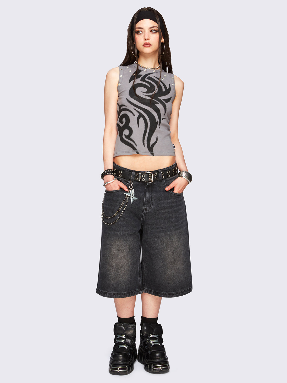 Black washed longline denim jorts with removable chain and wide-leg fit and knee-length cut.