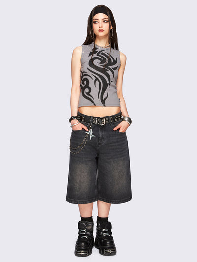 Black washed longline denim jorts with removable chain and wide-leg fit and knee-length cut.