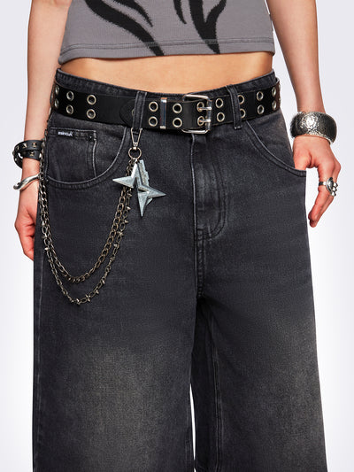 Black washed longline denim jorts with removable chain and wide-leg fit and knee-length cut.