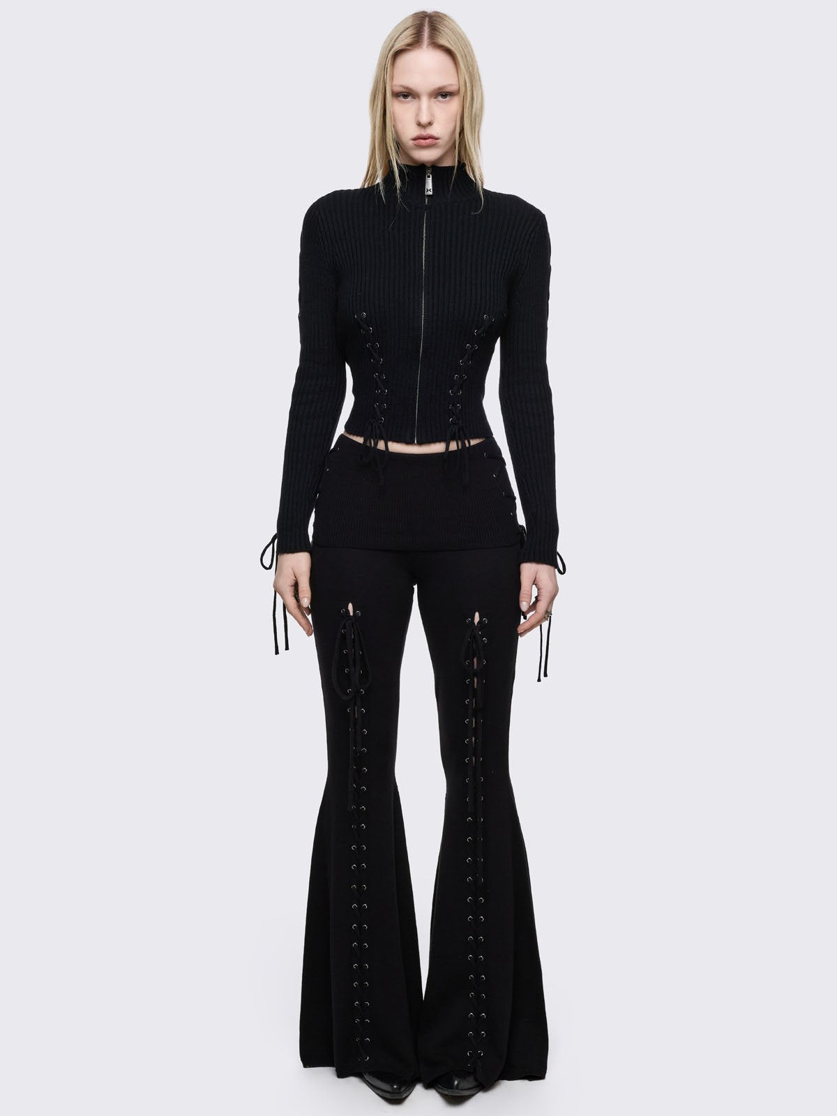 Black flare pants with front open lace-up corset details. 