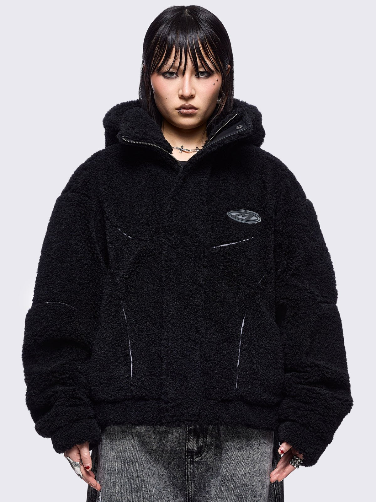 Black fleece hoodie jacket featuring grey piping and high neck hood.