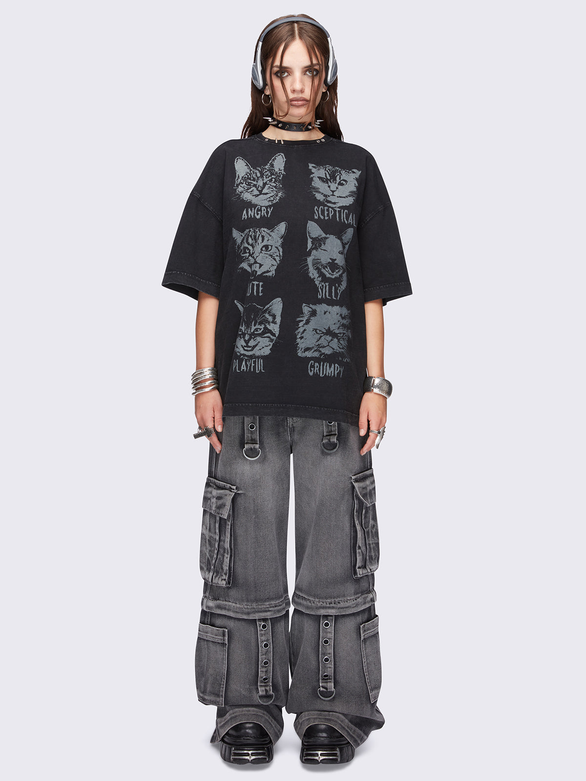 Black washed oversized t-shirt with kitty's mood graphic front print and eyelet and spike neckline details.