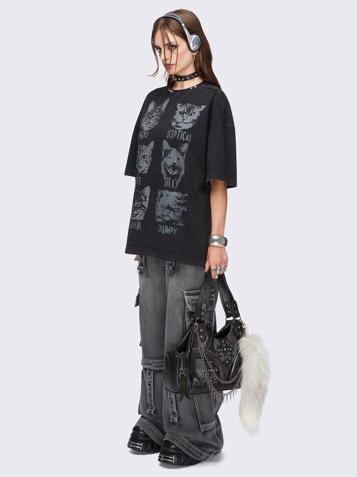 Black washed oversized t-shirt with kitty's mood graphic front print and eyelet and spike neckline details.