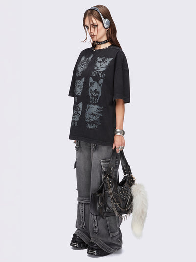 Black washed oversized t-shirt with kitty's mood graphic front print and eyelet and spike neckline details.