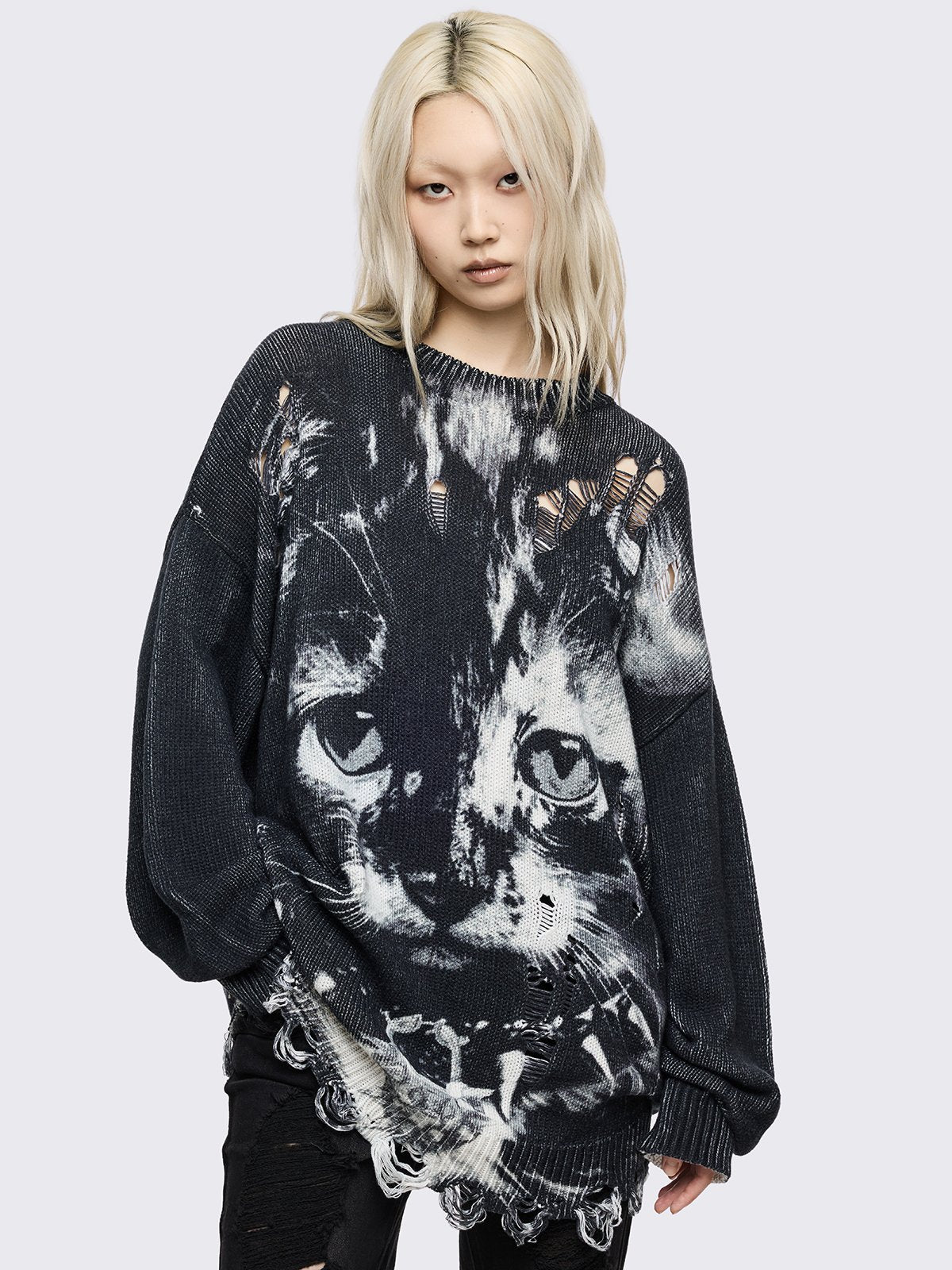 Oversized longline black knit sweater featuring a large white cat graphic and heavy deconstructed shredding throughout the body.