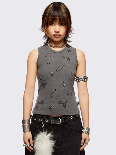 Sleeveless grey tank top with safety pins and piercing details. Grunge-style vibes. 