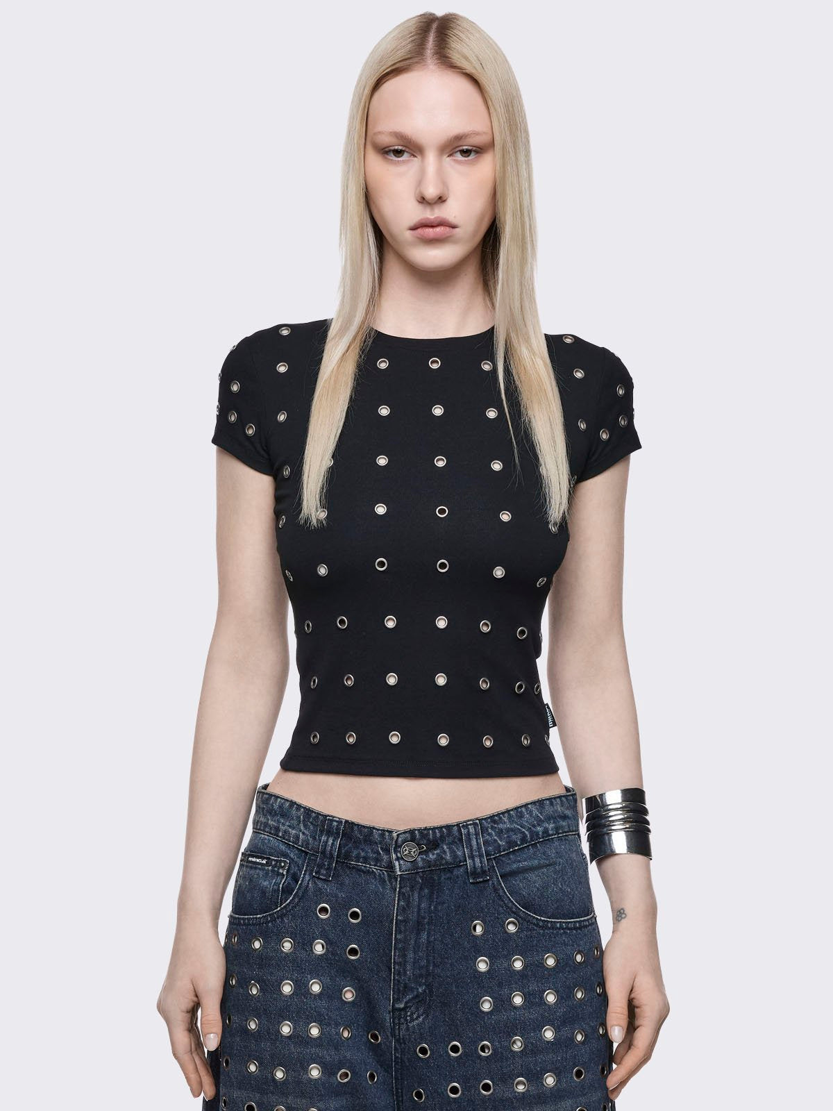 Black baby tee with silver eyelets. 